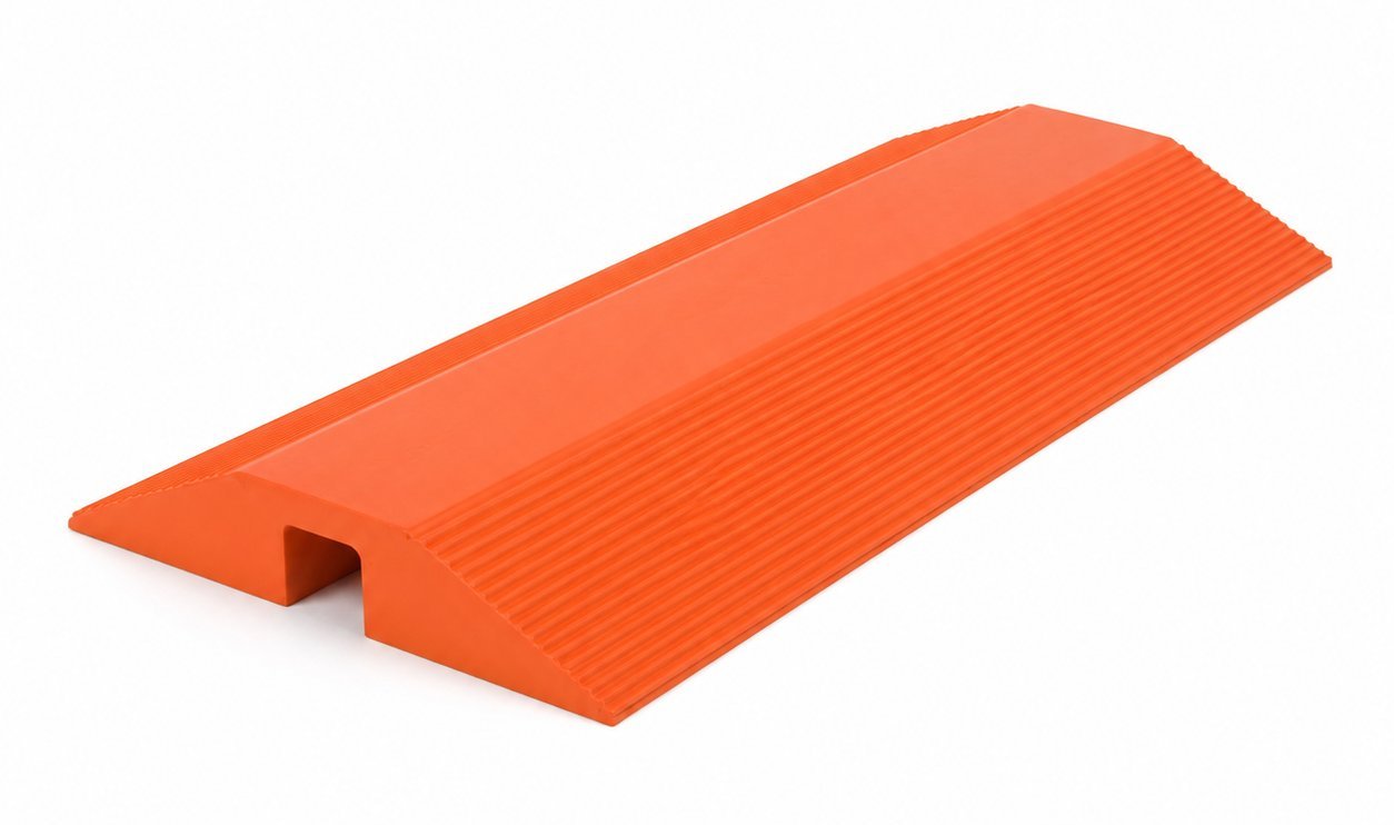Molded safety orange polyurethane cable and hose crossover ramp with a single tunnel and ribbed traction surface, manufactured by Comcast Urethane